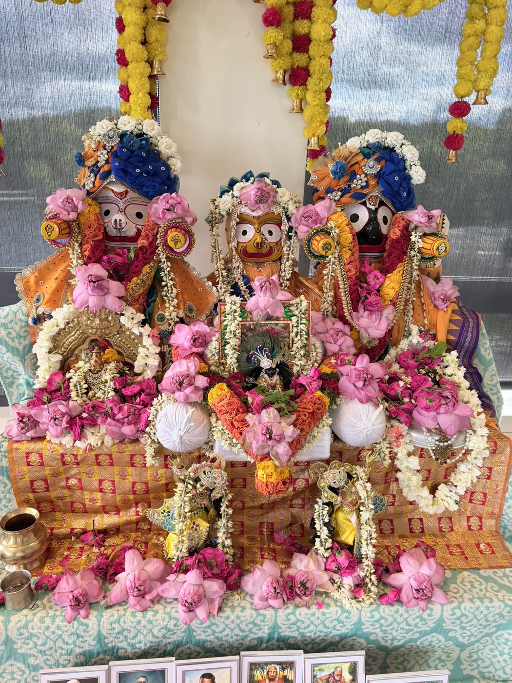 Śrī Śrī Jagannātha, Baladeva and Subhadrā on the flower-decked Janmāṣṭamī altar