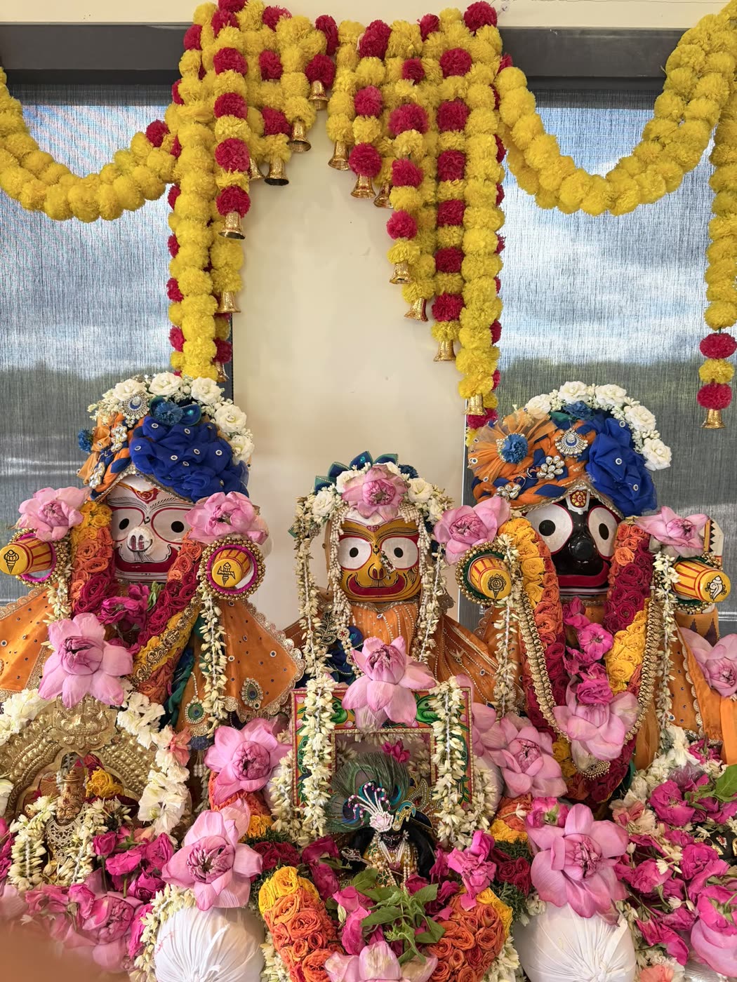 The altar framed by marigold garlands for Janmāṣṭamī darśana