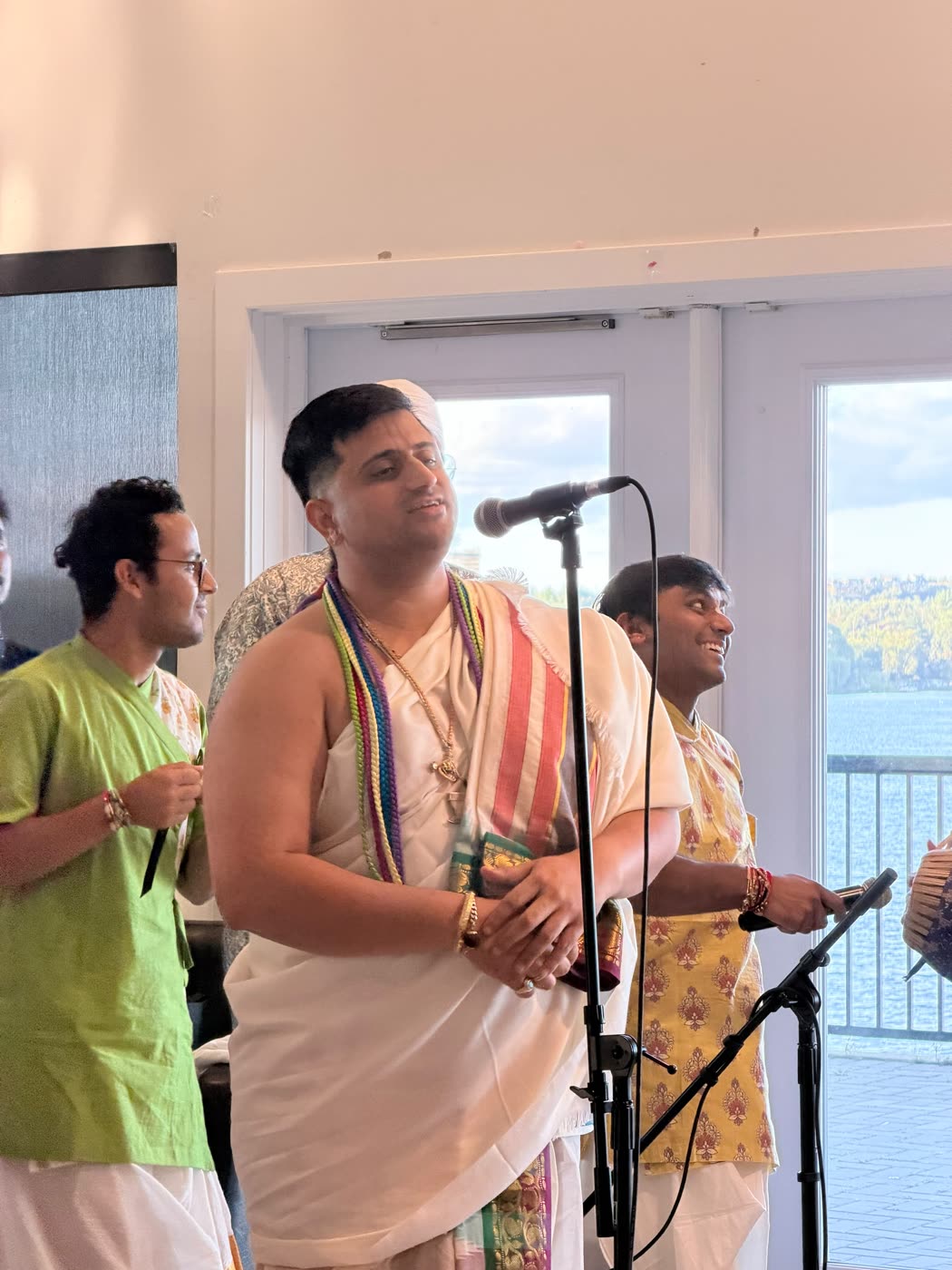 A devotee leading kīrtana at the microphone